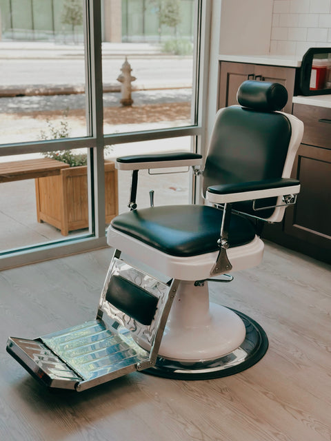 Barber chair in a salon setting with large windows at Olde Soul Barbershop in Mueller, Austin.