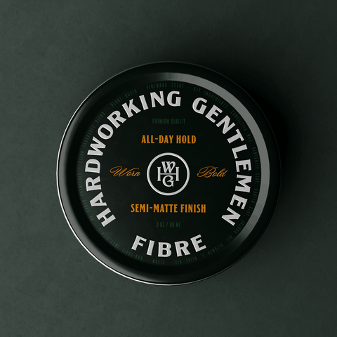 Container of Hardworking Gentlemen fibre product on a dark background