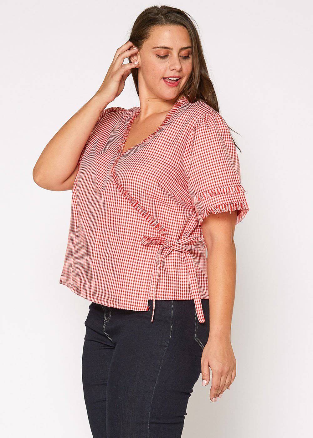 Plus Size Fringe Trim Gingham Wrap Blouse in Red Gingham by Shop at Konus